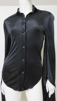 For Sale on 1stDibs - A fabulous black fine stretch silk shirt, top, blouse from Tom Ford for Gucci. It is semi fitted with a shirt collar, black mother of pearl Gucci inscribed Elegant Gucci Blouse For Evening, Elegant Gucci Blouse For Party, Gucci Formal Button-up Blouse, Gucci Button-up Blouse For Formal Occasions, Elegant Gucci Party Blouse, Gucci Collared Blouse For Formal Occasions, Gucci Black Top For Night Out, Elegant Gucci Button-up Blouse, Gucci Formal Collared Blouse