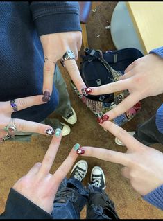 four people with their hands in the shape of five fingers, all showing different designs