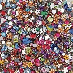 a large pile of different colored jewel stones