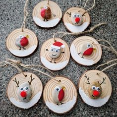 christmas ornaments made out of wood slices with reindeer faces and antlers hanging from strings