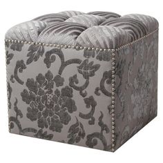 a gray and white ottoman sitting on top of a floor