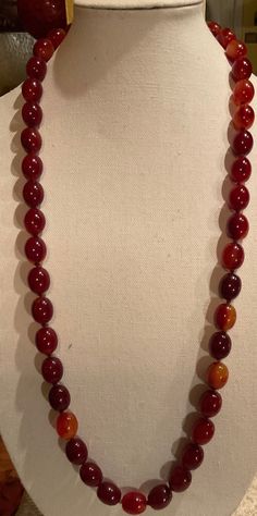 Up for Sale is this Beautiful DECO Cherry Amber Bakelite Necklace. This is a Beauty. It is in near Mint Condition. It measures 18" long. And weighs at 136 Grams. The entire necklace is Hand-Knotted. Plus there is no Clasp, as the necklace fits over the Head. Please See Photos. Classic Formal Necklace With Oval Beads, Classic Oval Bead Necklace For Formal Occasions, Classic Red Hand-strung Necklaces, Formal Single Strand Necklace With Oval Beads, Formal Single Strand Amber Necklace, Formal Amber Single Strand Necklace, Amber Single Strand Necklace For Formal Occasions, Formal Oval Necklace With Polished Beads, Bakelite Necklace