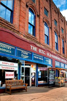 an old brick building with many signs on the front and side windows that read the b c o f e d