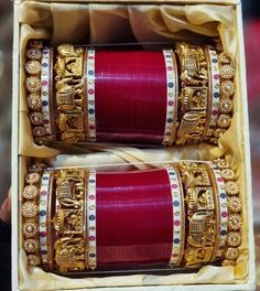 two red and gold bangles in a box