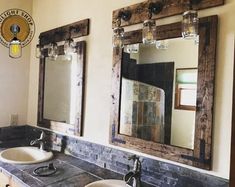 two sinks in a bathroom with mirrors and lights on the wall above them, along with an old fashioned light fixture