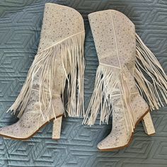 Gorgeous Knee High Boots! The Asire Boot By Jessica Simpson In White, Glittering In Clear Rhinestones, And The Bejeweled Fringe Gives A Fun And Ethereal Flare! Size 9.5! Worn Once For An Event In Nashville. They Are In Excellent Condition And Have Been Stored Upright With Pool Noodles Inserted To Keep Shape. Small Defects Are Pictured A Few Rhinestones Missing From The Back Of One Heel, And One Piece Of Fringe Has Been Pulled Off On The Inside Of One Boot. These Boots Will Turn Heads And They Ru Dressy Cowgirl Boots, White Embellished Snip Toe Boots, White Embellished Boots With Pointed Toe, White Leather Boots With Rhinestones, White Rhinestone Boots For Fall, White Embellished Boots With Round Toe, Elegant Boots With Rhinestone Fringe And Round Toe, Glamorous Boots With Rhinestone Fringe And Round Toe, Glamorous White Embellished Boots