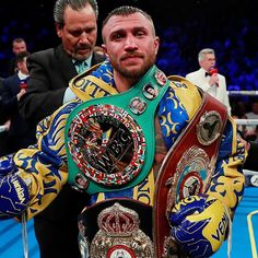 a man standing next to another man in a boxing ring