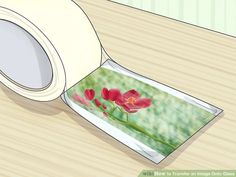 a roll of white tape with red flowers on it next to a wooden table top