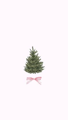 a small christmas tree with a pink bow