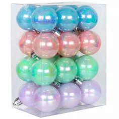 a clear box filled with lots of different colored christmas ornament balls on top of each other