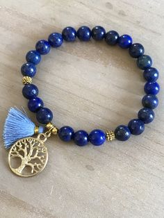 This beautiful bracelet is made of 8mm lapis lazuli beads, gold spacers and it is adorned with a tree of life pendant and a mini tassel 20mm. The bracelet shown fits to 7.75 inches wrist but you can choose your own wrist size. Lapis Lazuli *third eye and throat chakra *stimulates wisdom and good judgement *activates the higher mind and enhances intellectual ability *enhances the desire for knowledge, truth and understanding *is a stone of truth that deepens communication with calmness and loving Bohemian Lapis Lazuli Beaded Bracelets, Bohemian Lapis Lazuli Beaded Bracelets As Gift, Bohemian Lapis Lazuli Bracelet As A Gift, Bohemian Lapis Lazuli Bracelet For Gift, Handmade Bohemian Lapis Lazuli Bracelets, Bohemian Jewelry With Tree Of Life For Meditation, Bohemian Jewelry For Meditation With Tree Of Life, Bohemian Tree Of Life Jewelry For Meditation, Spiritual Bracelets