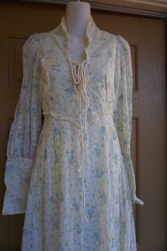 "Gunne sax style or possibly Gunne Sax prairie dress. Zippers at the wrists. Laces at the bust. Good condition - has sewn on back under the laces that could be easily removed - see last photo. Measurements taken across front laid flat 17.5\" across front armpit to armpit 13.5\" across front of waist (ties tighter) 20\" across hips 59\" length" Spring Peasant Prairie Dress With Long Sleeves, Spring Peasant Prairie Dress With Floral Print, Spring Victorian Lace Dress For Daywear, Spring Peasant Style Prairie Dress With Floral Print, Peasant Style Dresses With Lace Trim For Spring, Spring Long Sleeve Peasant Prairie Dress, Spring Floral Print Prairie Peasant Dress, Spring Floral Print Peasant Prairie Dress, Fitted Bohemian Prairie Dress For Spring