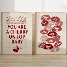 two posters with lipstick prints on them in an empty room