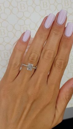 a woman's hand with pink manies and a diamond ring