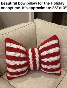 a crocheted bow pillow for the holiday or anytime it's approximately 25x13