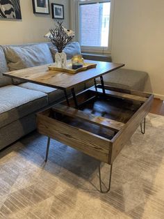 a living room with a couch, table and coffee table in it's center