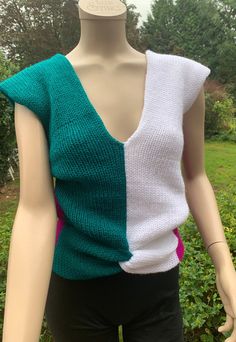 a female mannequin wearing a green and white top