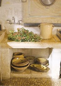 an old fashioned kitchen with pots and pans on the counter