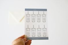 a person holding up a card with drinks on it