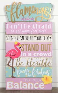 a wooden sign that says flamingo, don't be afraid to get your feet wet