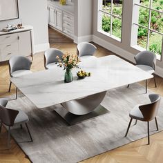 a dining table with chairs around it and a vase filled with flowers on the table