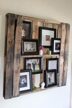 an old pallet is used as a shelf for pictures and other things to hang on the wall