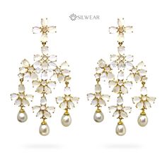 Elevate your elegance with our White Moonstone Chandelier Earrings, adorned with delicate Freshwater Pearl Drops. Expertly crafted in 925 Sterling Silver and adorned with natural gemstones, these exquisite earrings offer a fusion of sophistication and charm. The gold-plated design adds a touch of luxury, making them the perfect accessory to grace special occasions or accentuate your daily style. Immerse yourself in the enchanting allure of moonstone and the timeless beauty of pearls, all intricately set in a designer masterpiece that radiates grace and allure. CATEGORY : Chandelier Earrings STYLE : Contemporary METAL : 925 Sterling Silver GEMSTONES / DECORATIONS : Natural White Moonstone and natural Fresh Water Pearls. GROSS WEIGHT : 44 gms apx. DIMENSION : Length - 3.46 Inch (8.8 cms) , W Elegant Pearl Drop Chandelier Earrings For Reception, Elegant Pearl Drop Danglers For Reception, White Pearl Drop Earrings For Reception, Elegant White Pearl Earrings For Reception, White Chandbali Pearl Earrings For Reception, Elegant White Pearl Drop Danglers, White Pearl Drop Bridal Earrings For Reception, Elegant Chandbali Chandelier Earrings For Wedding, White Drop Earrings For Reception