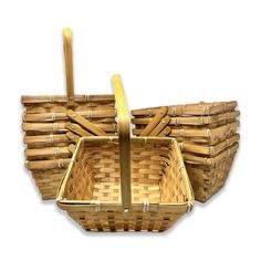 a set of four bamboo baskets sitting on top of each other in front of a white background