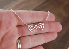 Double infinity necklace in sterling silver, sterling silver necklace, infinity symbol, eternity necklace, friendship necklace, mother's day A sterling silver double infinity symbol link that measures 0.91 x 0.39 inches (23 x 10mm) is attached to a sterling silver chain that can be any length up to 22 inches. It is secured with a sterling silver spring ring clasp. Your purchase will arrive in a jewelry box ready for gift giving or as a gift for yourself! Enter my shop here: jersey608jewelry.etsy Sterling Silver Infinity Necklace In White Gold, Nickel-free Silver Infinity Jewelry, Dainty Infinity Necklace As Gift For Her, Minimalist Nickel-free Infinity Jewelry, Sterling Silver Infinity Necklace With Adjustable Chain, Silver Infinity Dainty Necklace, Silver Infinity Necklace In Dainty Style, Silver Infinity Necklace With Delicate Chain, Silver Infinity Jewelry With Adjustable Chain