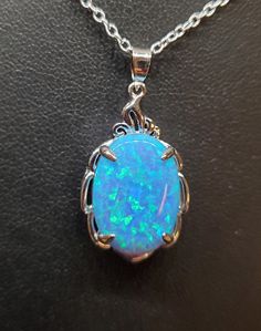 "Beautiful Light Sky Blue Opal Necklace, 13x18mm Lab Created Opal With Green And Lavender Fire, See Video! 925 Sterling Pendant With Decorative Top, 18\" Sterling Chain. Chain Length Options Available By Messaging Seller At Time Of Purchase. Gift Box Included." Green And Lavender, Blue Opal Necklace, Light Sky Blue, Opal Necklace, Blue Opal, Sterling Silver Pendant, Chain Lengths, Chain Length, Sterling Silver Pendants