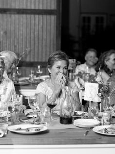 a group of people sitting at a table with plates and glasses in front of them