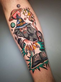 a man's arm with an old school wizard tattoo on the left inner forearm