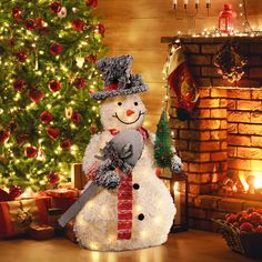 a snowman is standing in front of a christmas tree