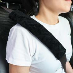 a woman sitting in the back seat of a car with her head resting on an arm rest