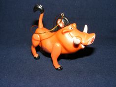 an orange toy bull with a pair of glasses on it's head and mouth