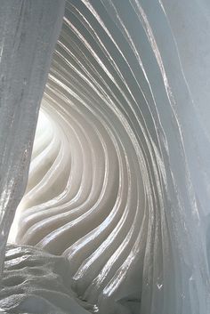 the inside of an ice cave that looks like it is moving in different directions and shapes