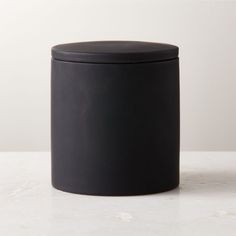 a black container sitting on top of a white counter