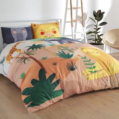 a bed with an animal themed comforter and pillows