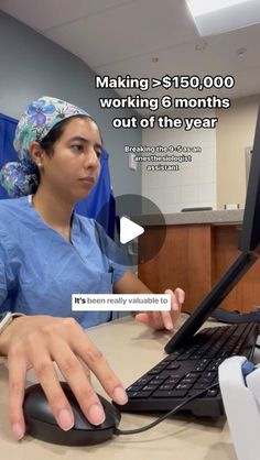 a woman in scrubs sitting at a desk with a keyboard and mouse on it