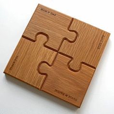 a wooden puzzle piece sitting on top of a white table