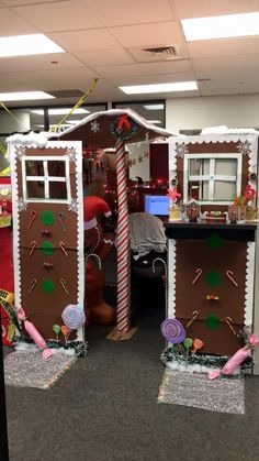 an office cubicle decorated for christmas with gingerbread houses and candy canes on the doors