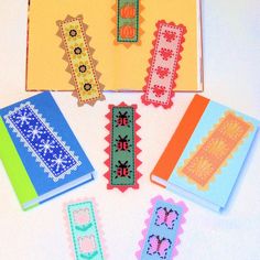 cross stitch bookmarks are arranged on a table