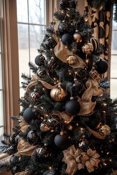 a black and gold christmas tree with ornaments