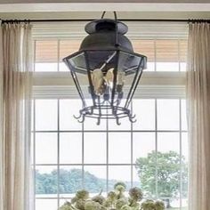 a dining room table and chairs with vases on it