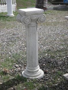 a stone pillar in the middle of a field