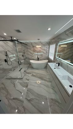 a large bathroom with marble floors and walls