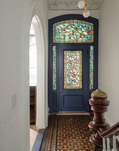 a blue front door with stained glass windows