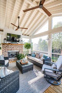 an outdoor living room with wicker furniture and a flat screen tv