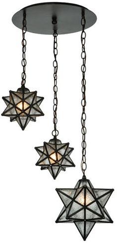 three lights that are hanging from chains on a light fixture, one is star of david