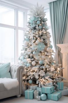 a white christmas tree with blue and silver ornaments